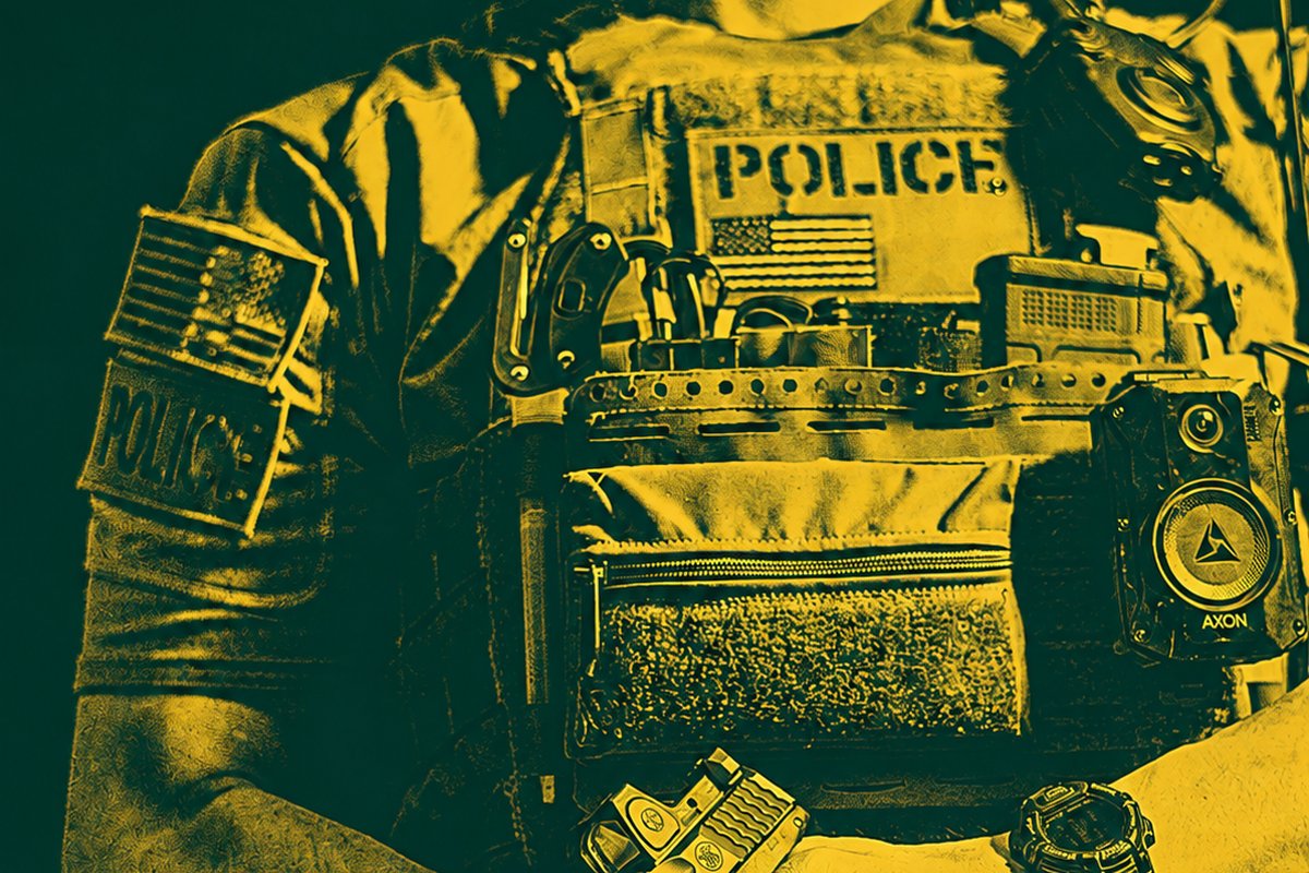 Law enforcement officer's tactical vest with police patch and duty pistol